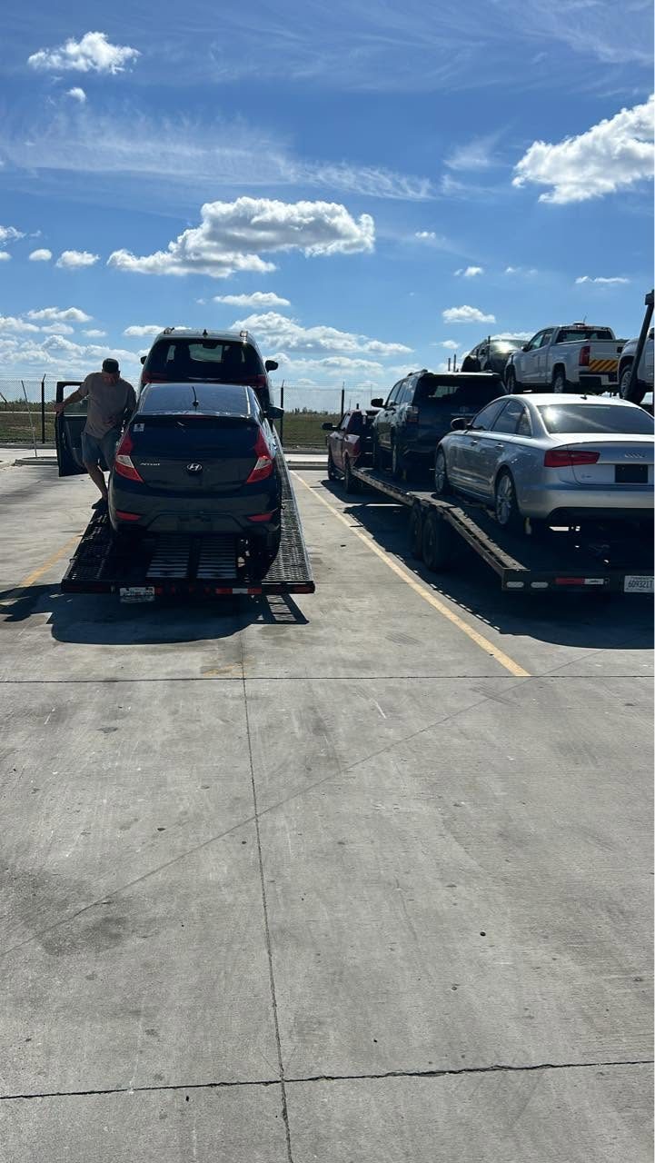 Vehicles loaded on the flatbed heading down the highway