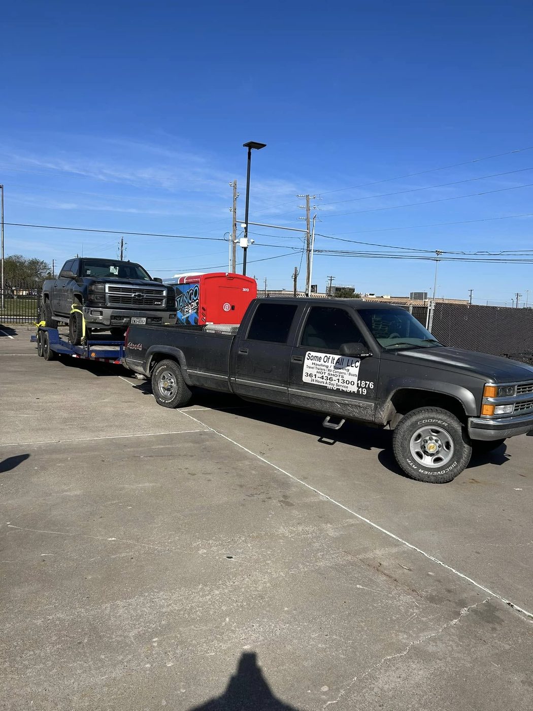 A truck loaded on the gooseneck flatbed, strapped and ready for transport