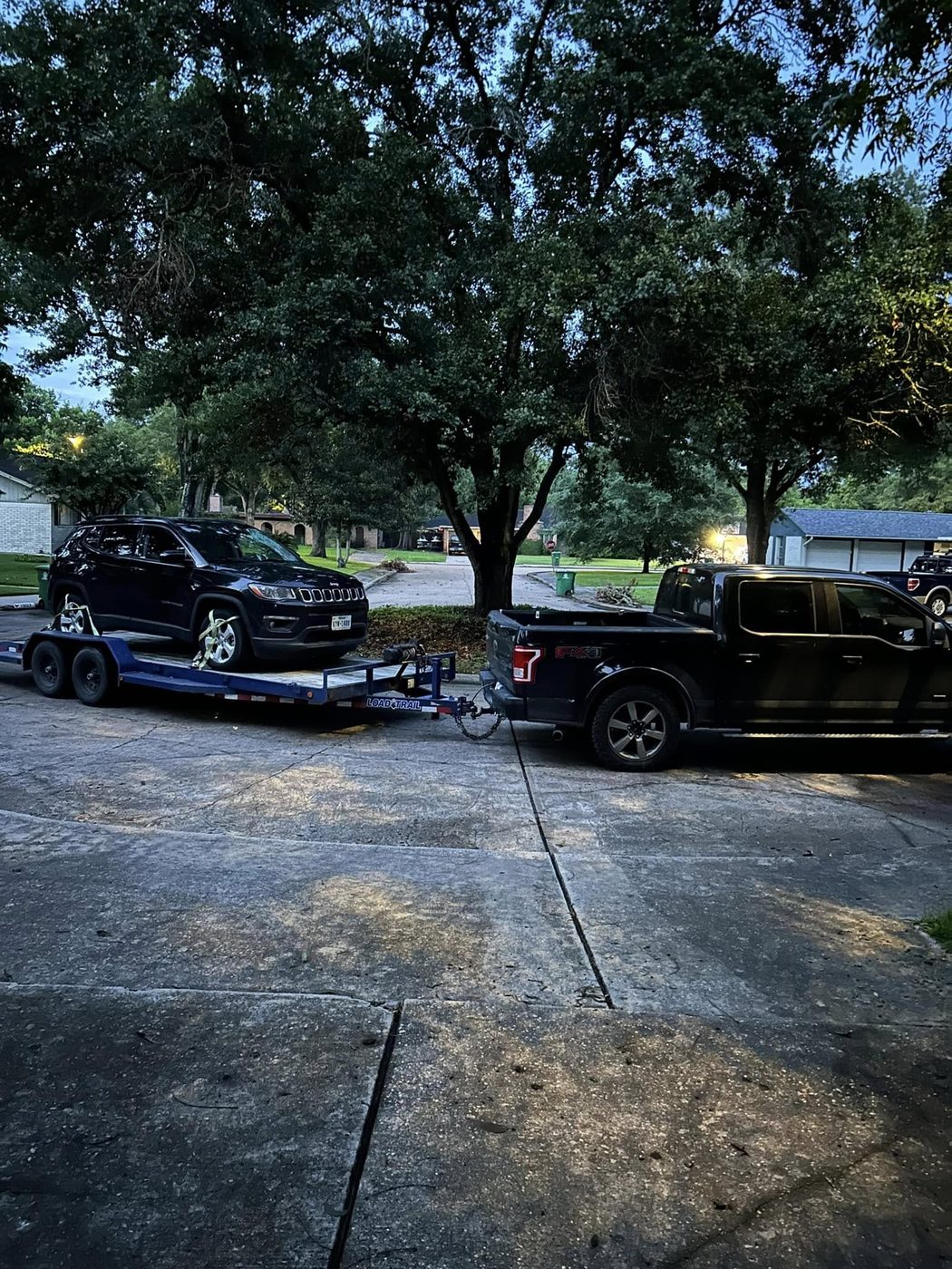 A vehicle loaded on the trailer near the water