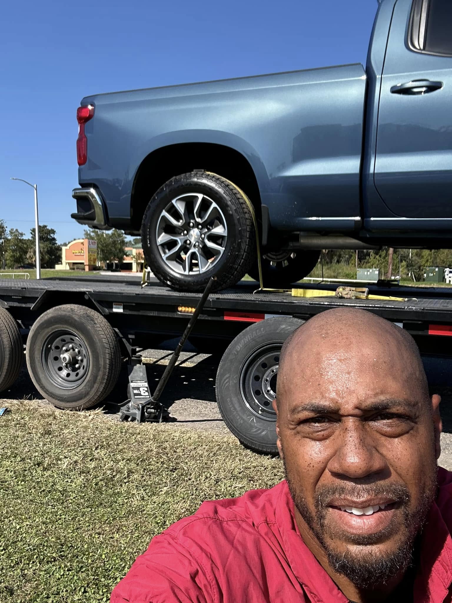 Donald with a Silverado loaded on the flatbed for transport