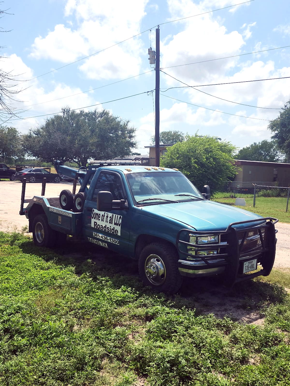 Some Of It All's blue Chevy tow truck, hand-lettered Roadside with the phone number, in Mathis TX